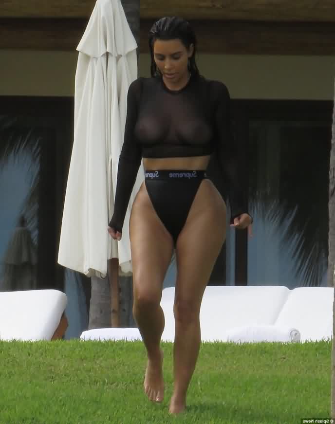 Kim Kardashian in sheer black top walking on green grass 700x871 - Kim Kardashian Nude Photo Collection